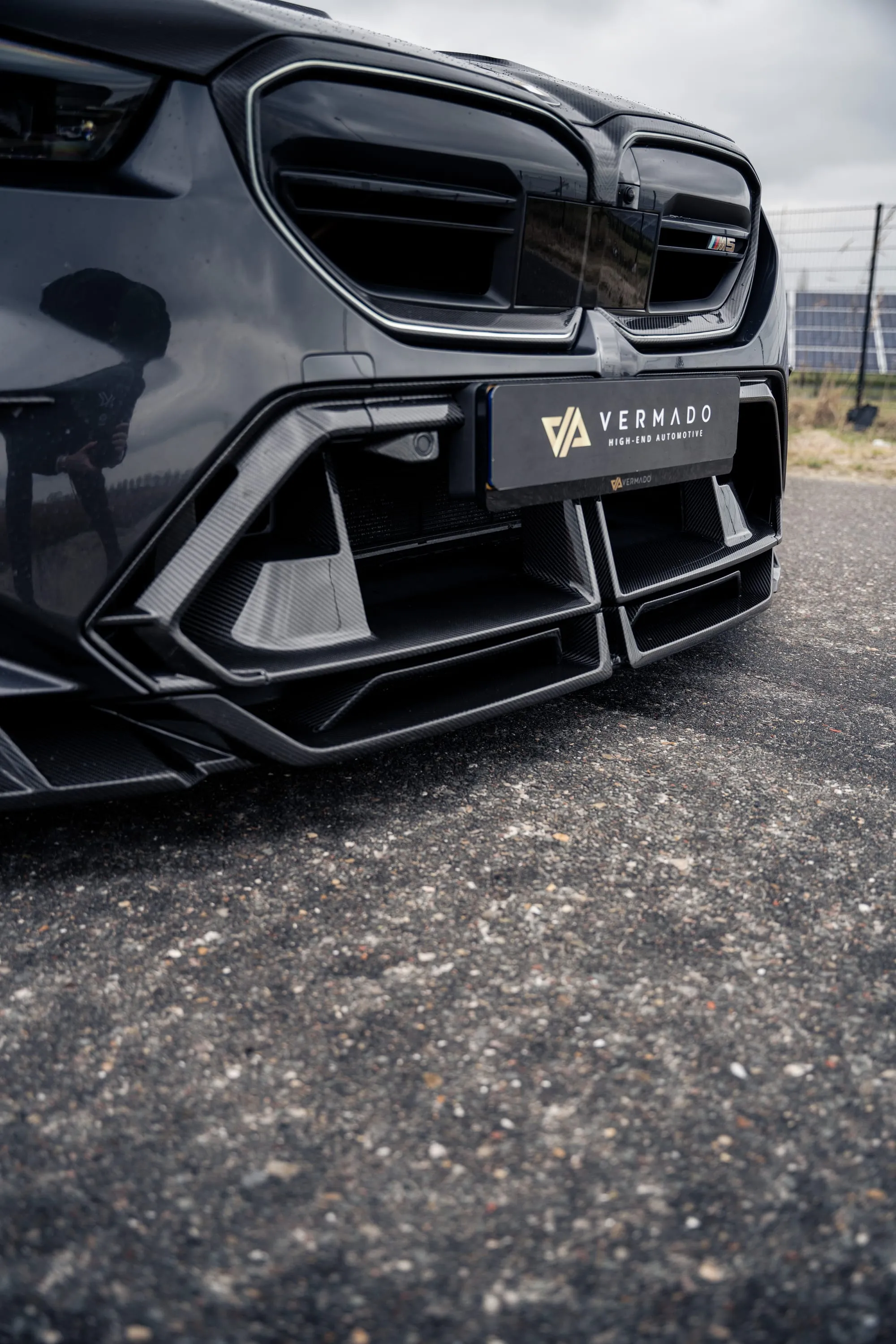 BMW M5 with carbon front splitter and Vermado plate